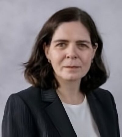 A business headshot of Dr. Margaret Czart, who is looking directly at the camera. She is wearing a black suit jacket with a white undershirt.